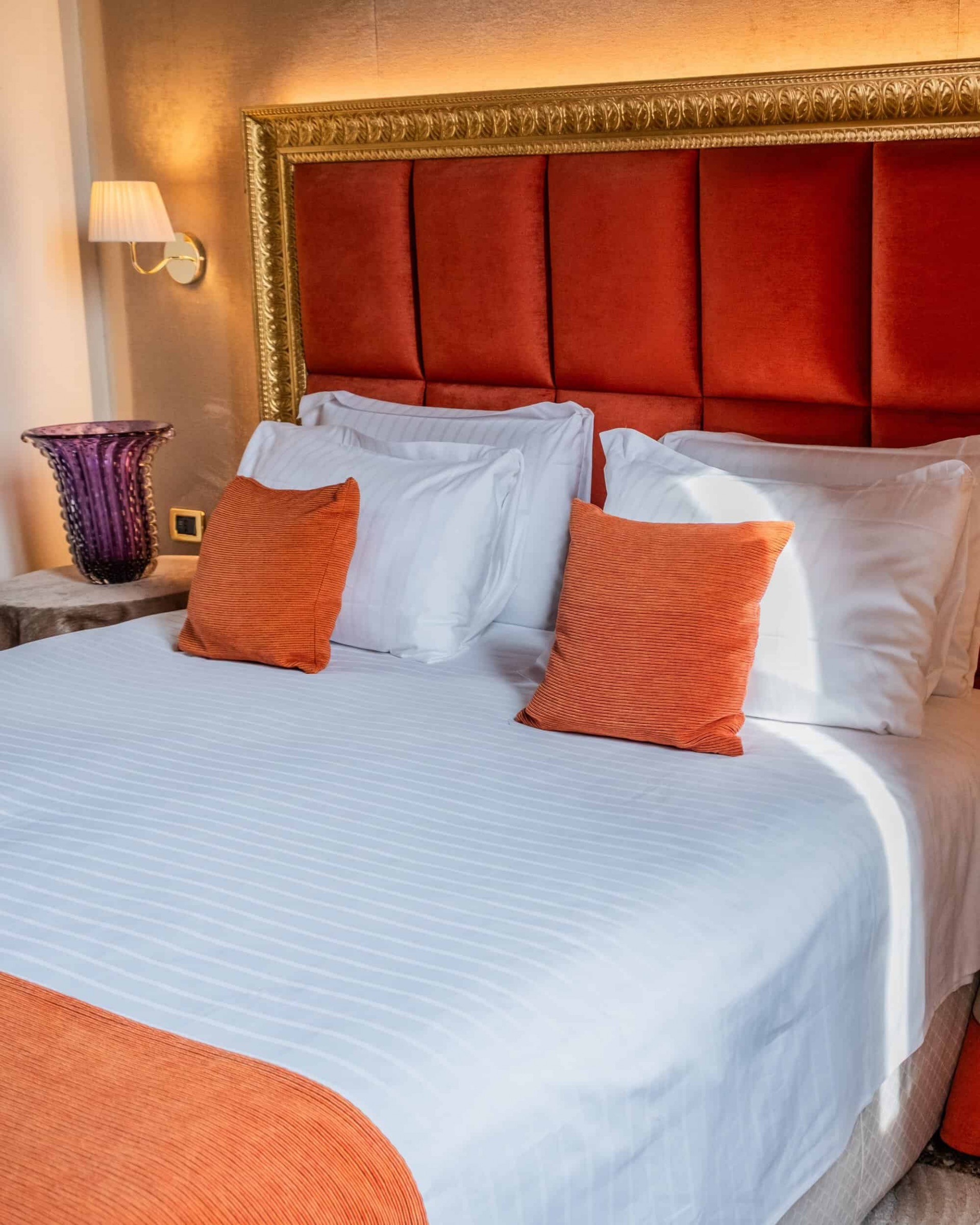 Comfortable bed with a selection of pillows at Ruzzini Palace Hotel in Venice